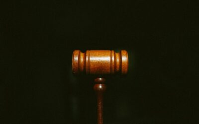 Open law books on a wooden desk symbolising final-round NLU admission