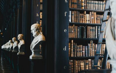 Wooden gavel resting beside legal books on a dark wood surface