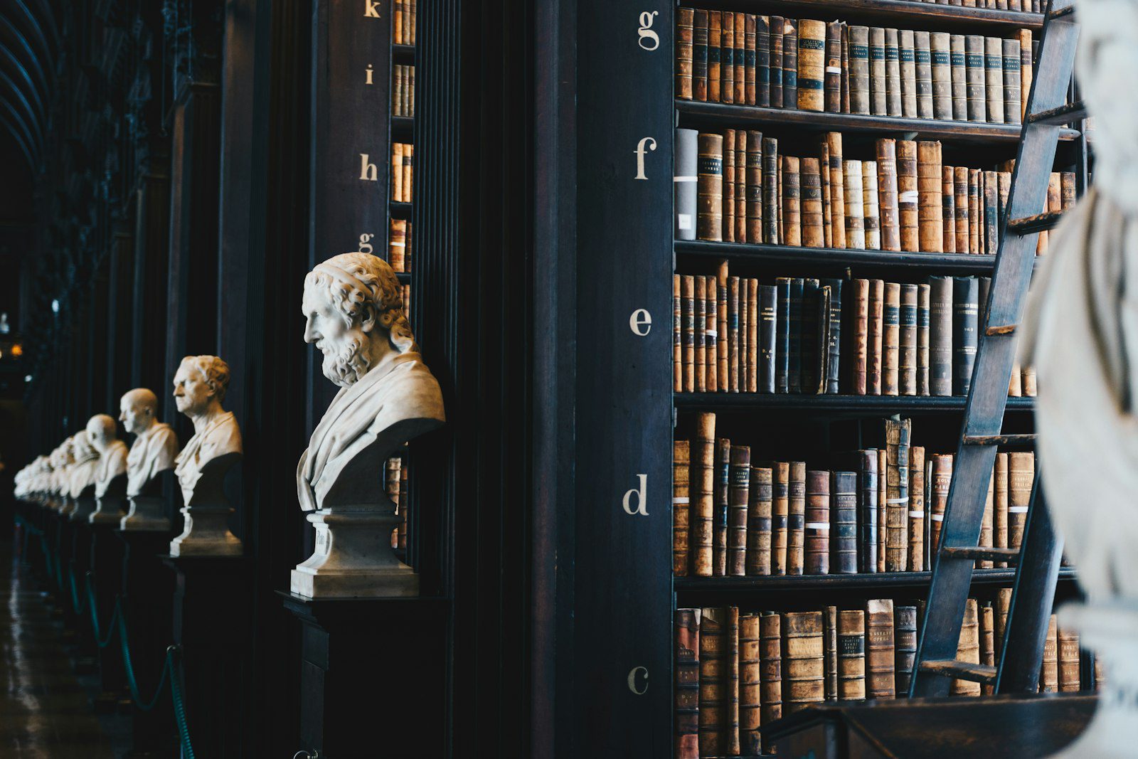Wooden gavel resting beside legal books on a dark wood surface