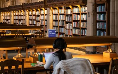 Student studying with books in a university library