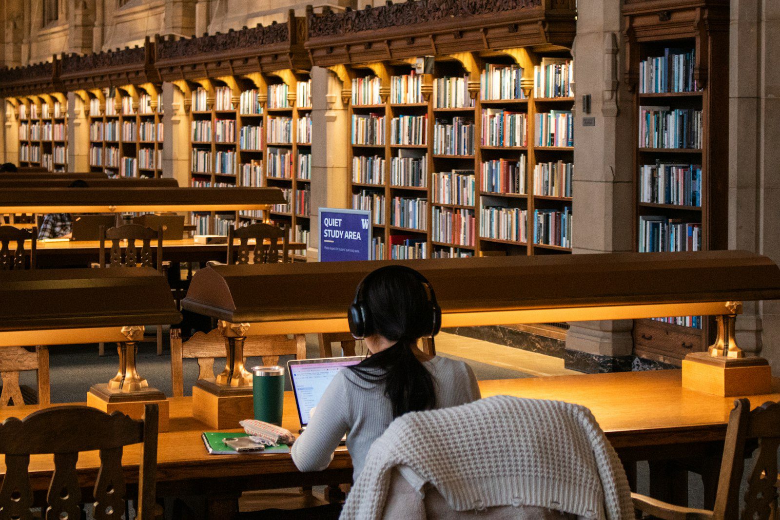 Student studying with books in a university library