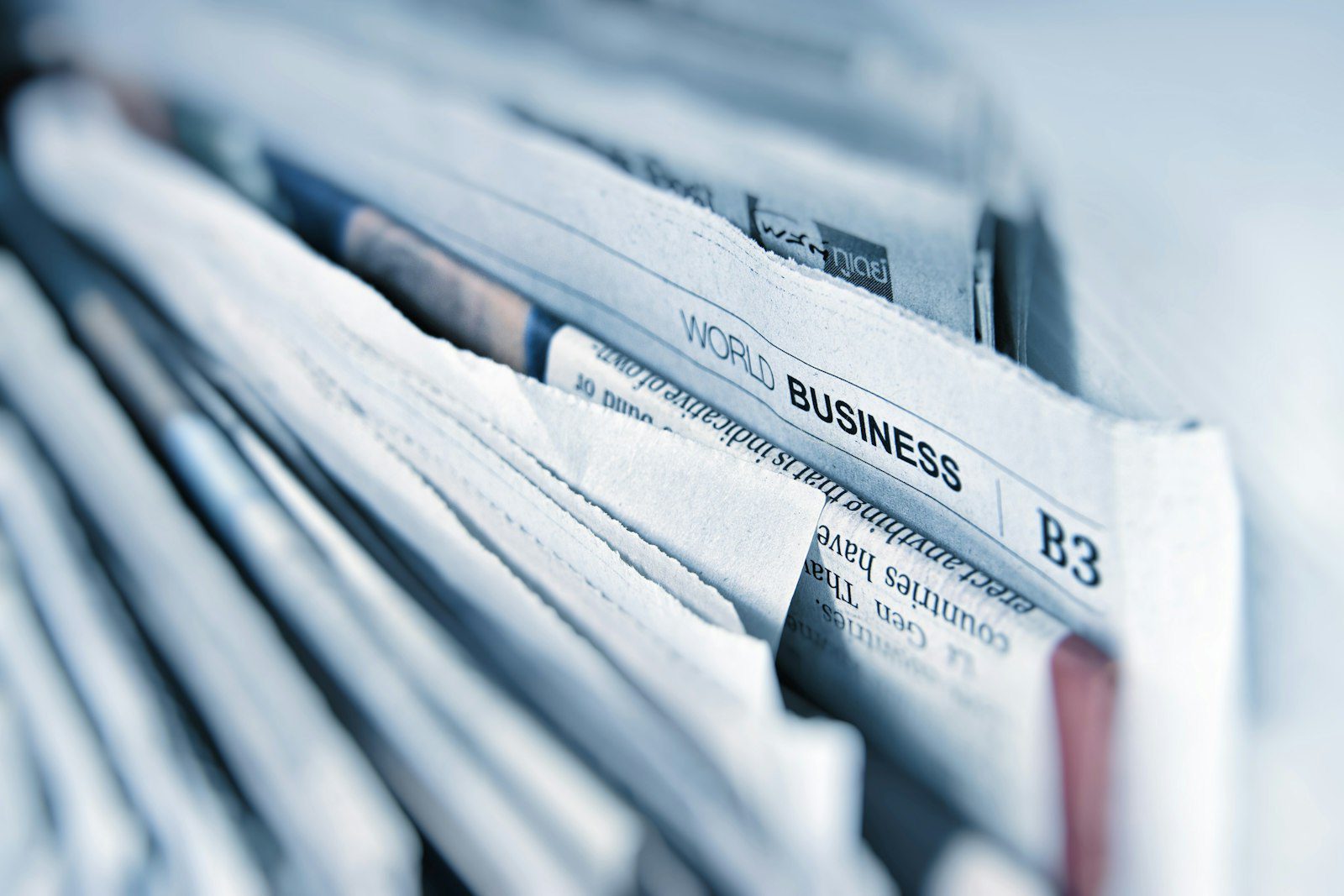 Law student reading editorial newspaper at study desk