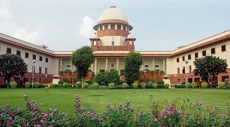 Supreme Court of India building exterior with national flag