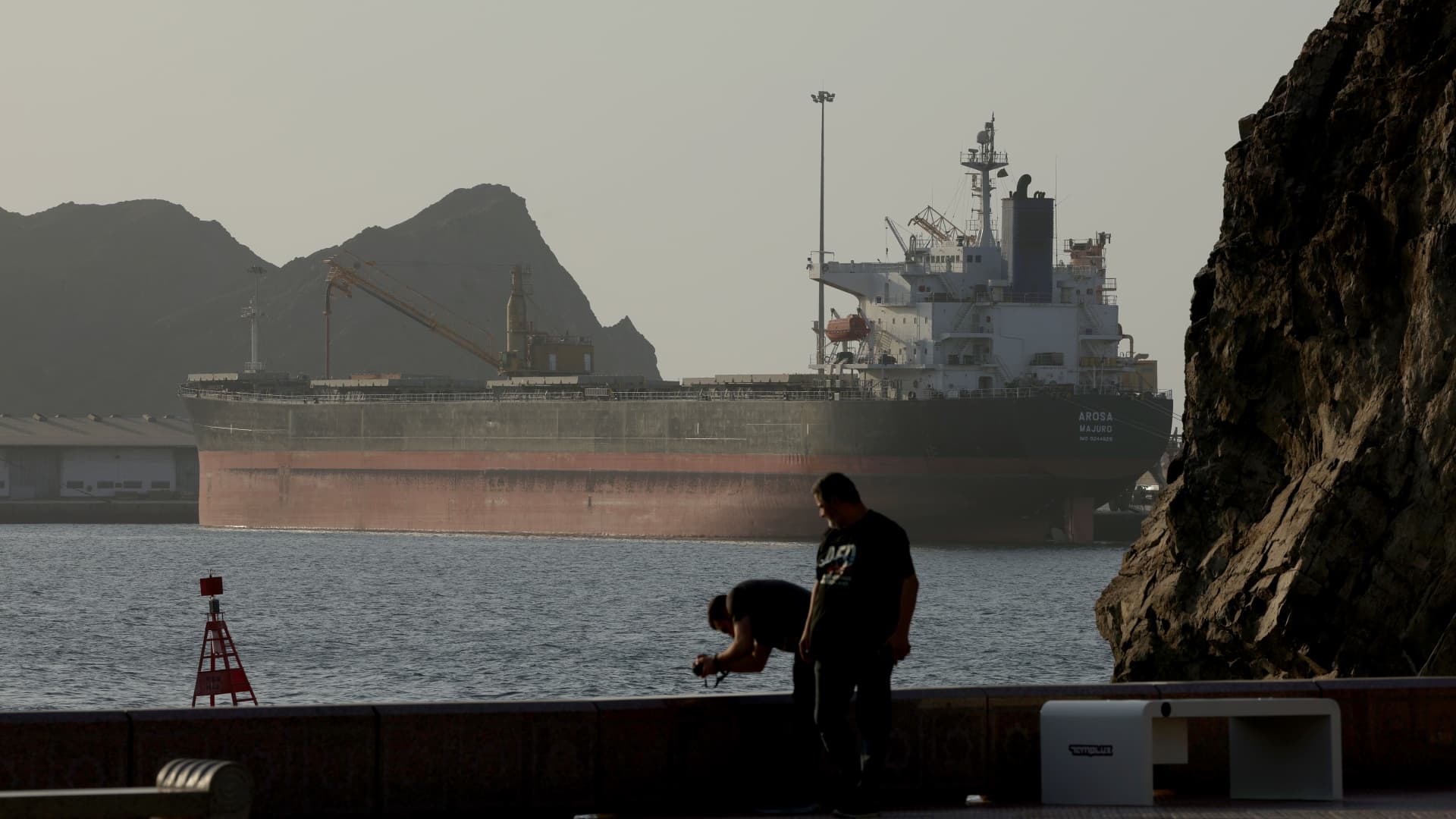 Oil tanker transiting a narrow maritime strait illustrating the Strait of Hormuz chokepoint