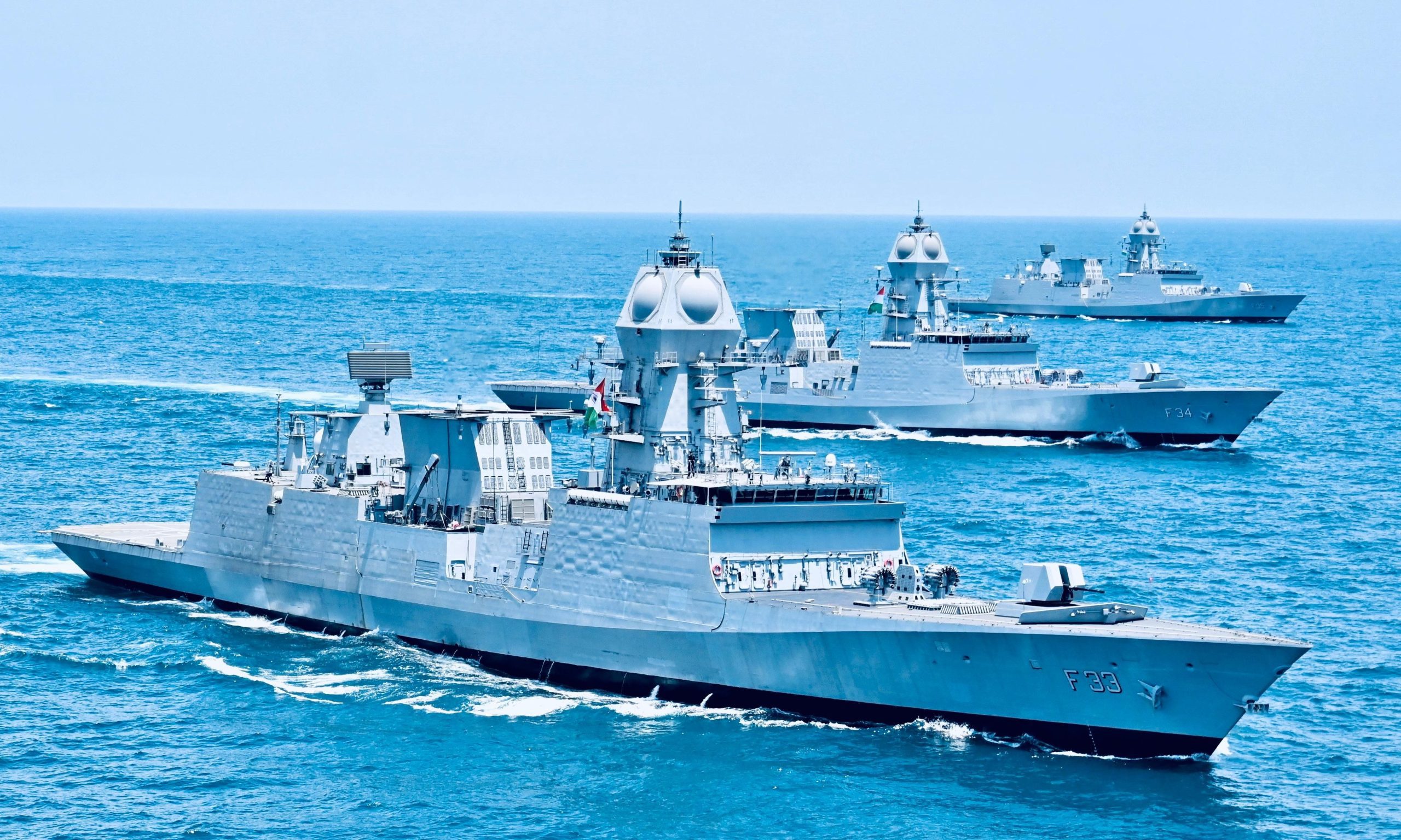Three indigenous Indian Navy stealth frigates sailing in formation at sea
