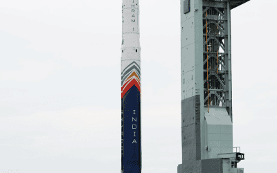 A private launch vehicle standing vertically on its launch pad at a spaceport
