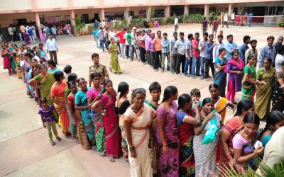 Voters standing in a queue at a polling booth