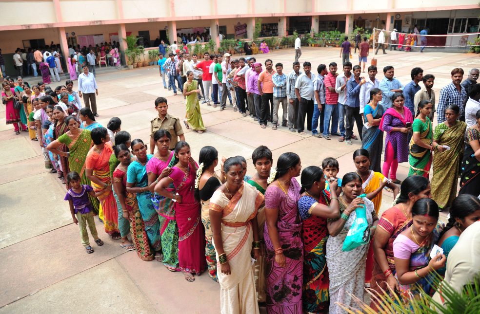 Voters standing in a queue at a polling booth