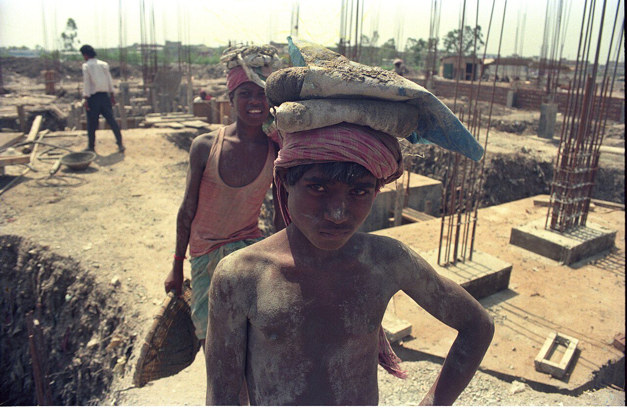 Construction labourers working at a building site in India