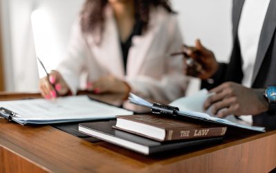 CLAT 2027 registration application form and law books on a desk