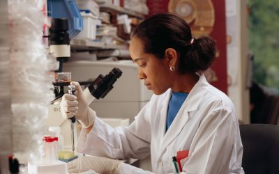 Researcher using a pipette to handle samples in a laboratory