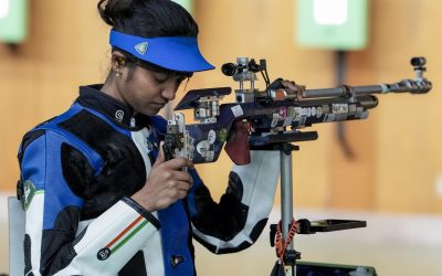 Indian woman shooter loading her air rifle at the Asian Games shooting range