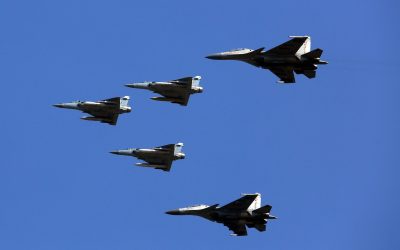 Indian Air Force Su-30 MKI and Mirage 2000 fighter aircraft flying in formation against a clear blue sky