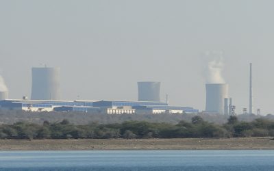 Cooling towers and reactor buildings of the nuclear power plant at Rawatbhata seen across a lake