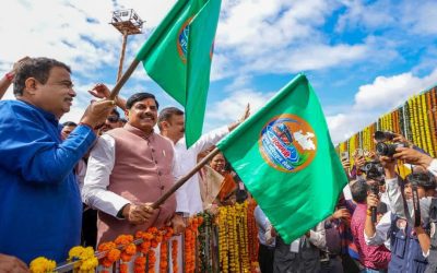 Union and state ministers waving green flags to flag off new public buses