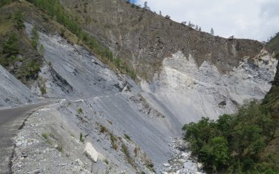 Large landslide scar on a Himalayan hillside beside a mountain road