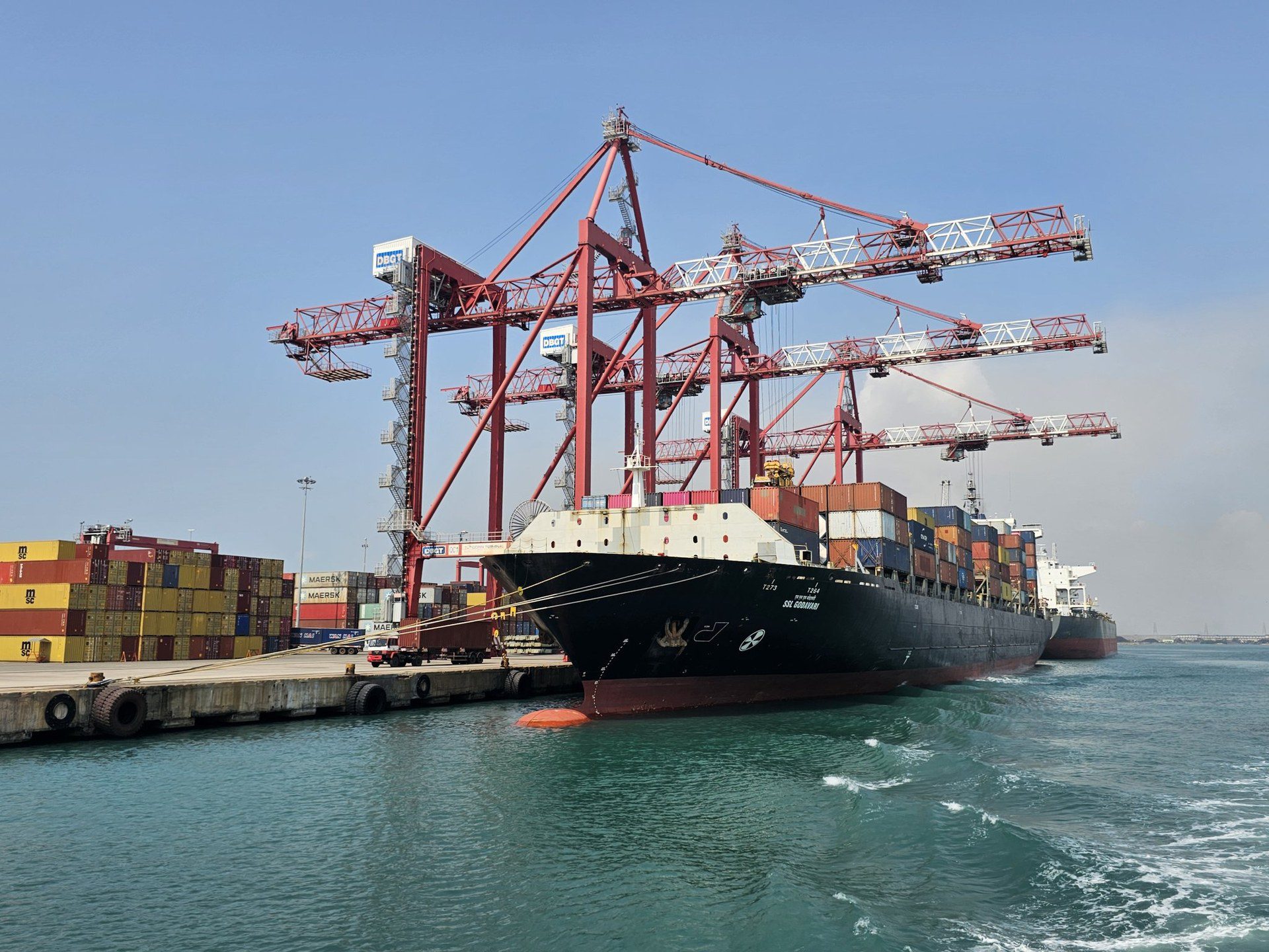 A container ship berthed under gantry cranes at a port terminal in Tuticorin