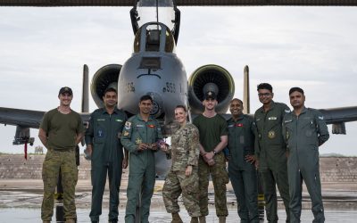 Air force personnel from India, Australia and the United States pose in front of a fighter aircraft during Exercise Tarang Shakti