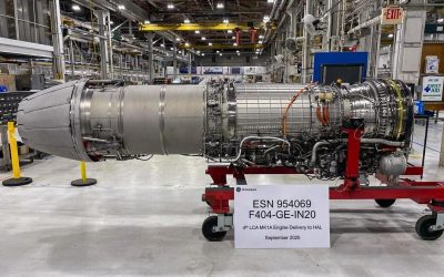 A GE F404-IN20 jet engine for the Tejas LCA Mk 1A on a red transport stand in a factory