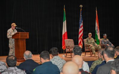 Naval officer addressing a change of command ceremony for a multinational maritime task force in Bahrain