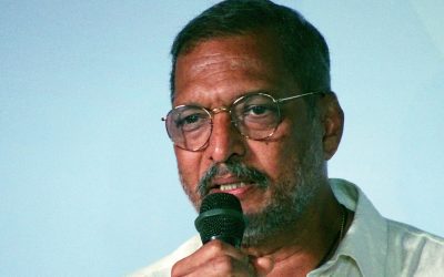 Actor Nana Patekar speaking into a microphone at a film festival event in Goa, 2017
