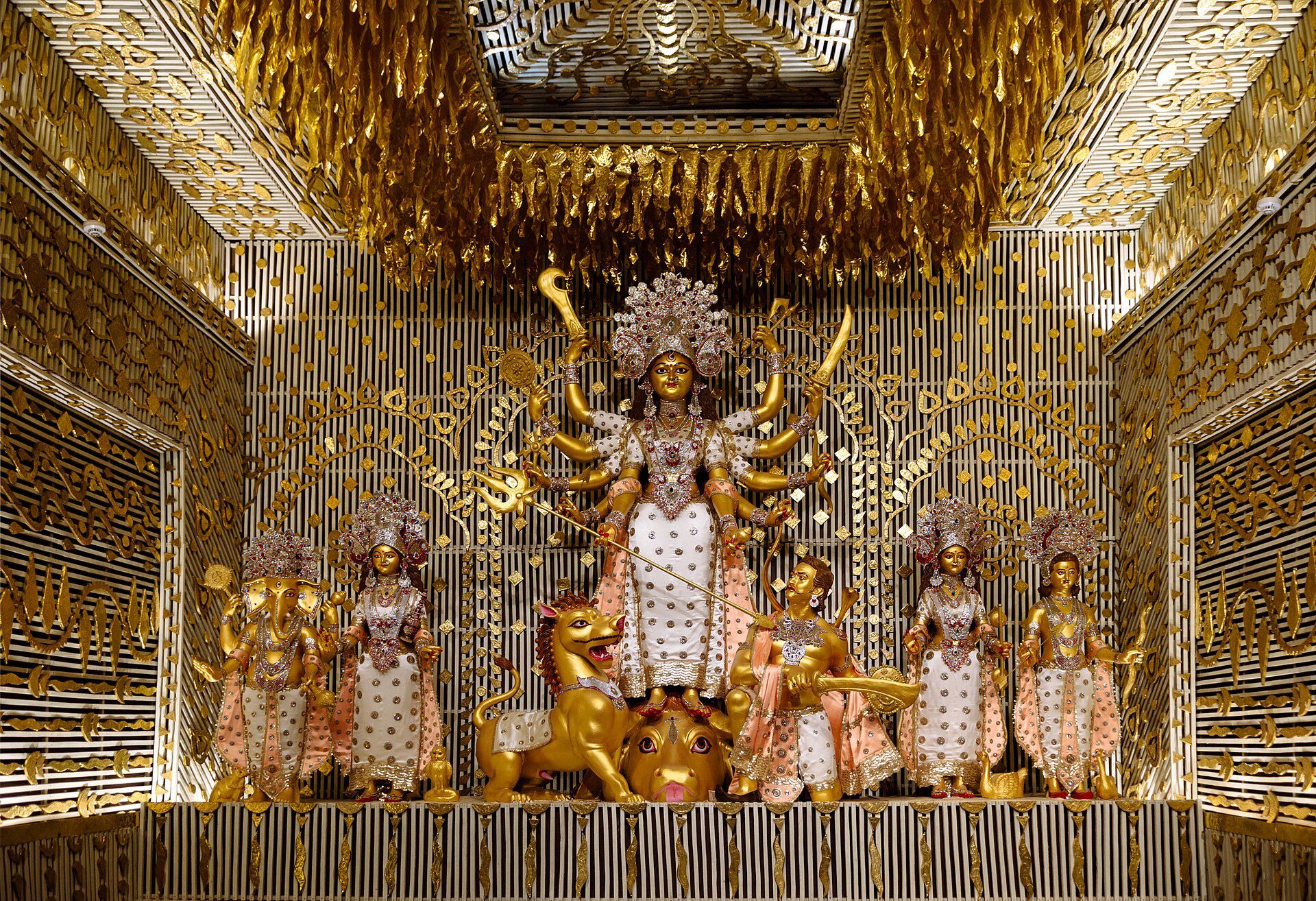 Durga Puja idol of the goddess Durga with her family inside a decorated pandal in Kolkata