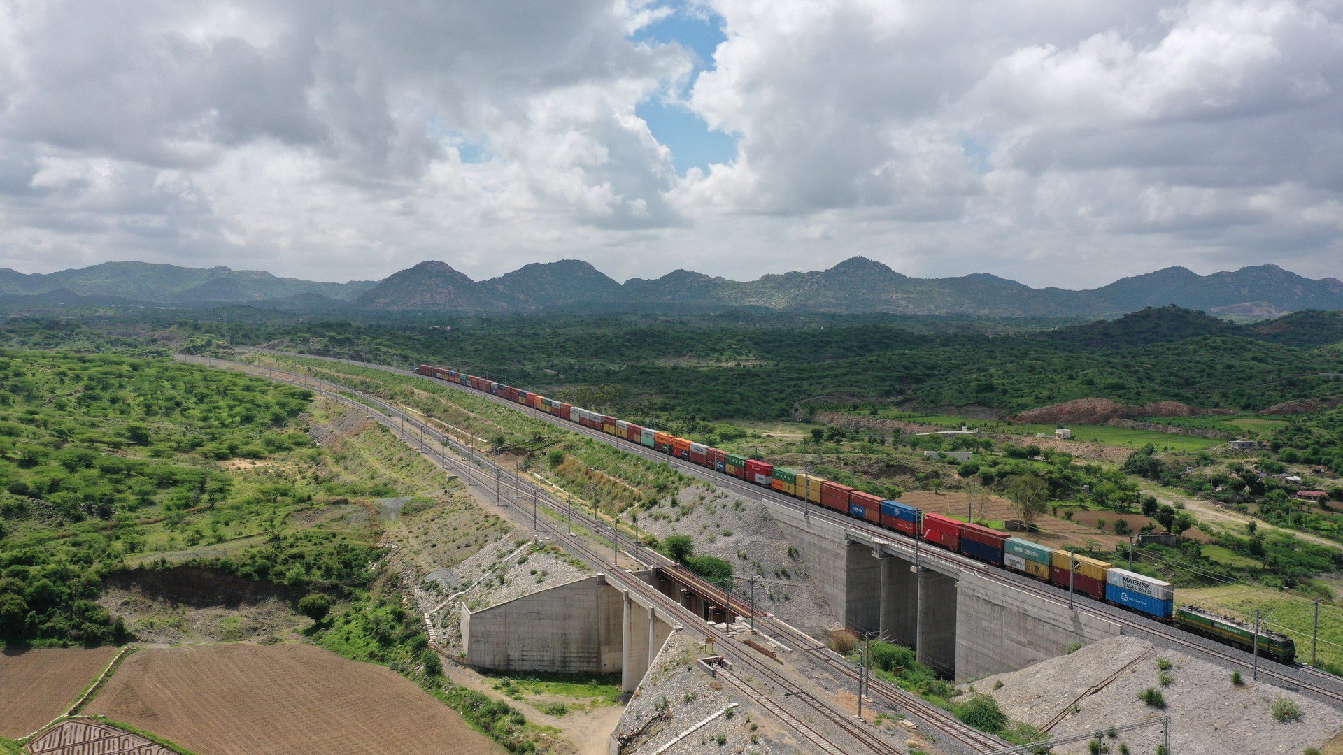 A container freight train running on the Western Dedicated Freight Corridor in India