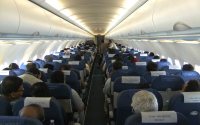 Passenger cabin of an Airbus A320 with overhead bins above the seat rows