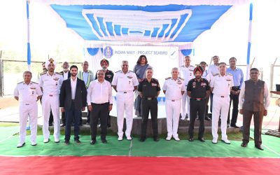 Naval and army officers pose in front of an Indian Navy Project Seabird banner at the Karwar naval base inauguration