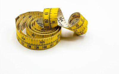 A measuring tape pulled out to compare two lengths