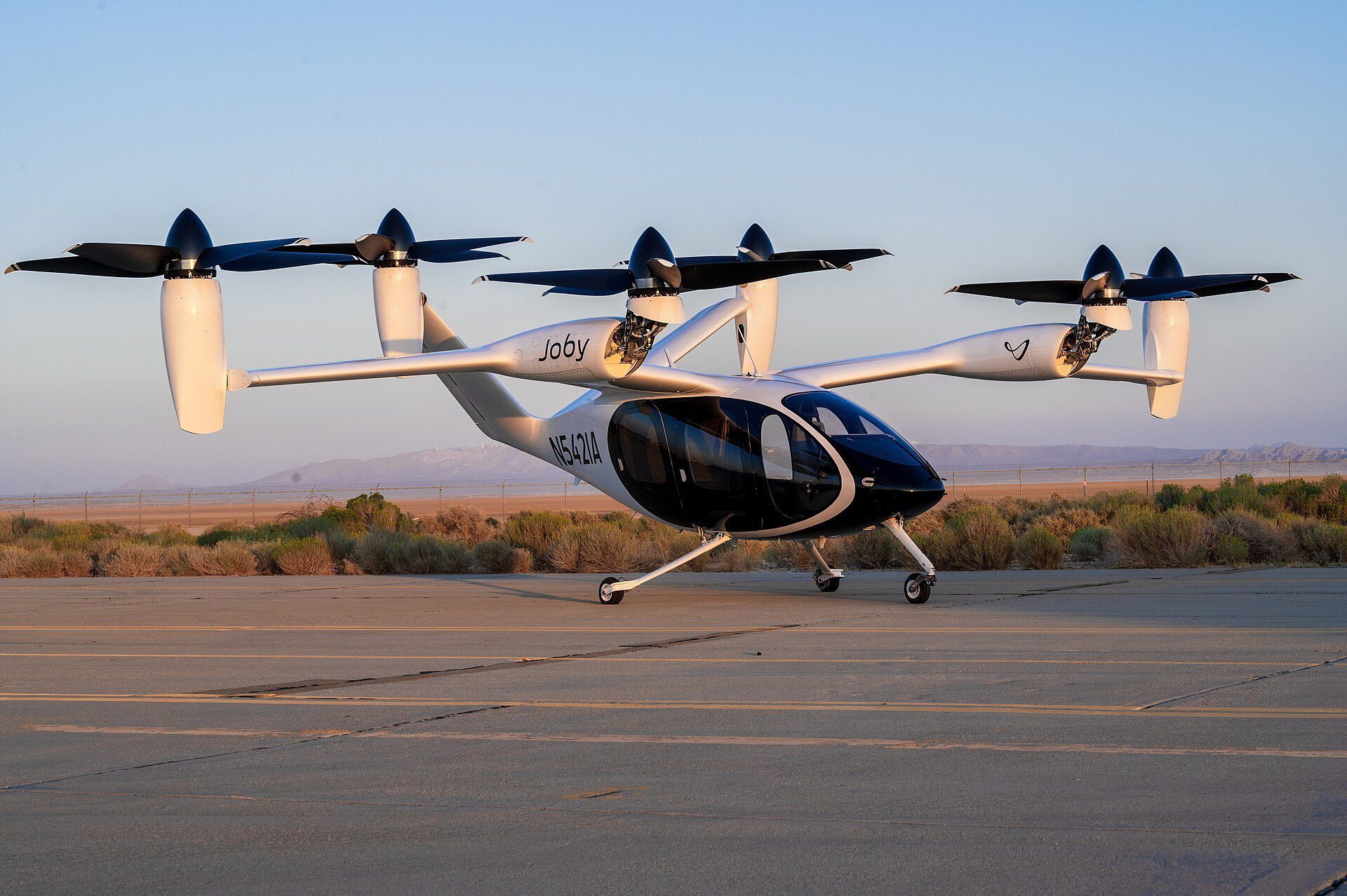 Experimental electric vertical take-off aircraft parked on an airfield